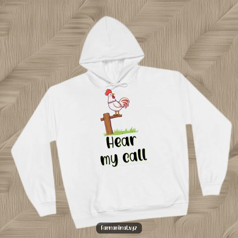 Funny rooster character proudly crowing atop a fence post, depicted on a warm and comfortable hoodie.